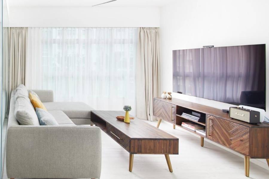 HDB BTO living room with grey sectional sofa and wood coffee table