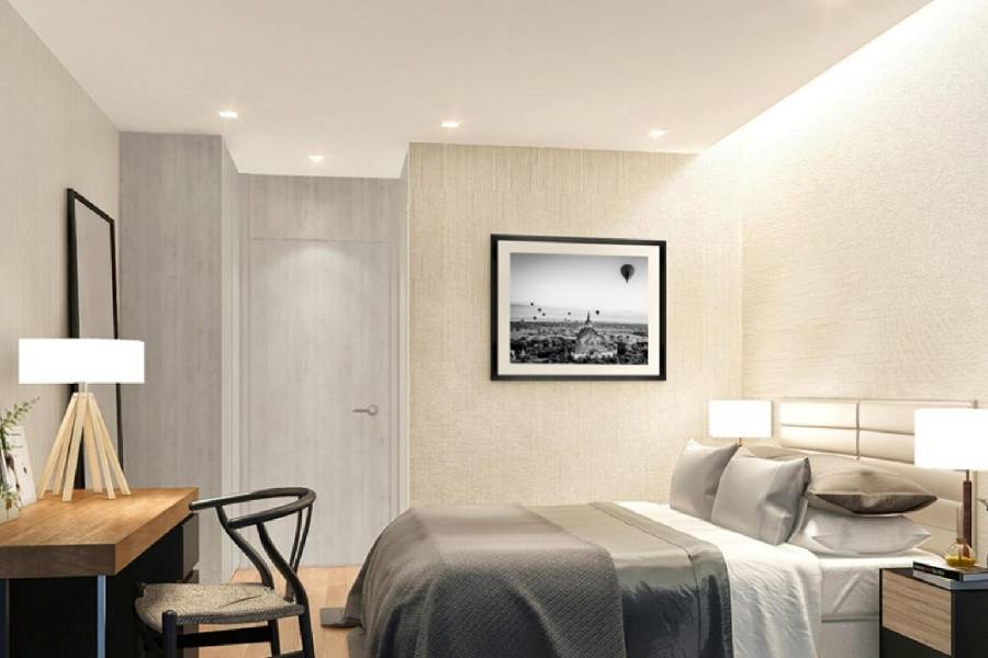 Condo bedroom renovation with framed artwork and neutral wallpaper