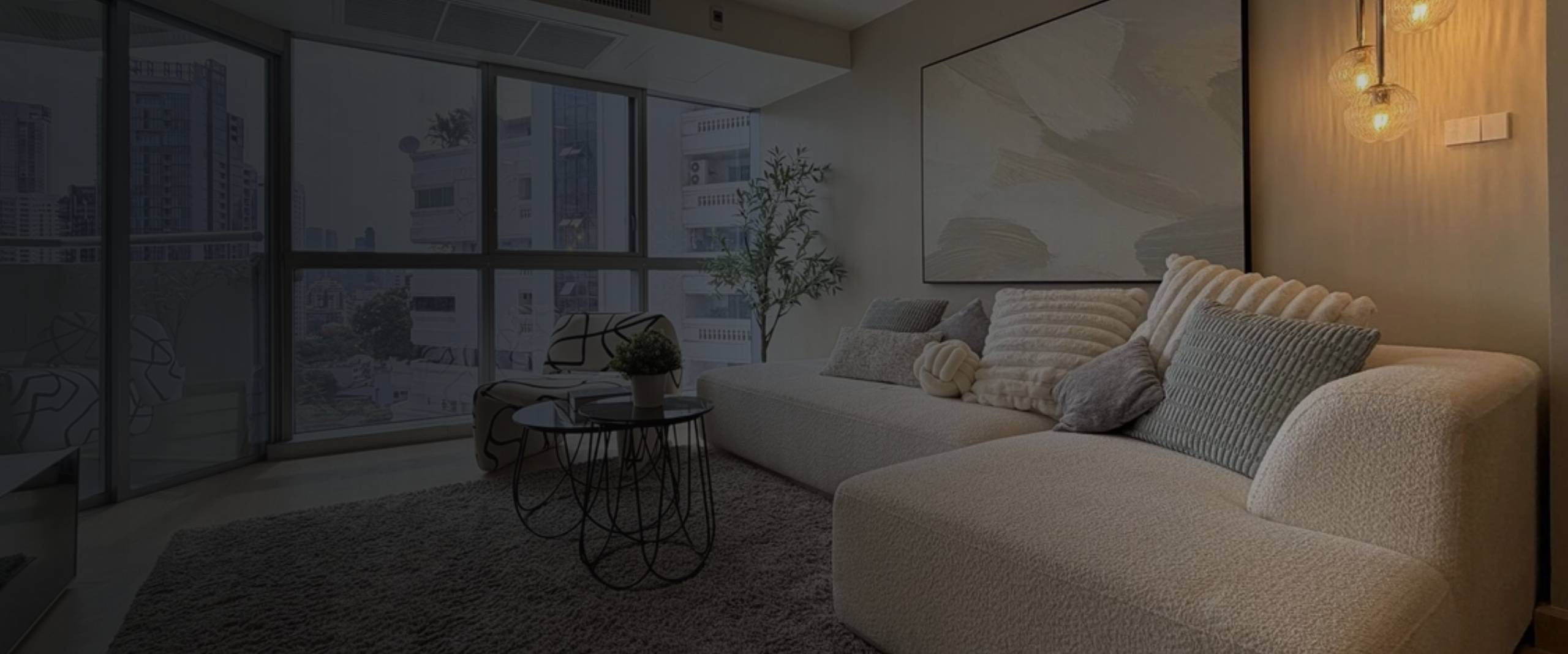 Condominium living room renovation with floor-to-ceiling windows and city skyline view by Thomson Renovation Contractor