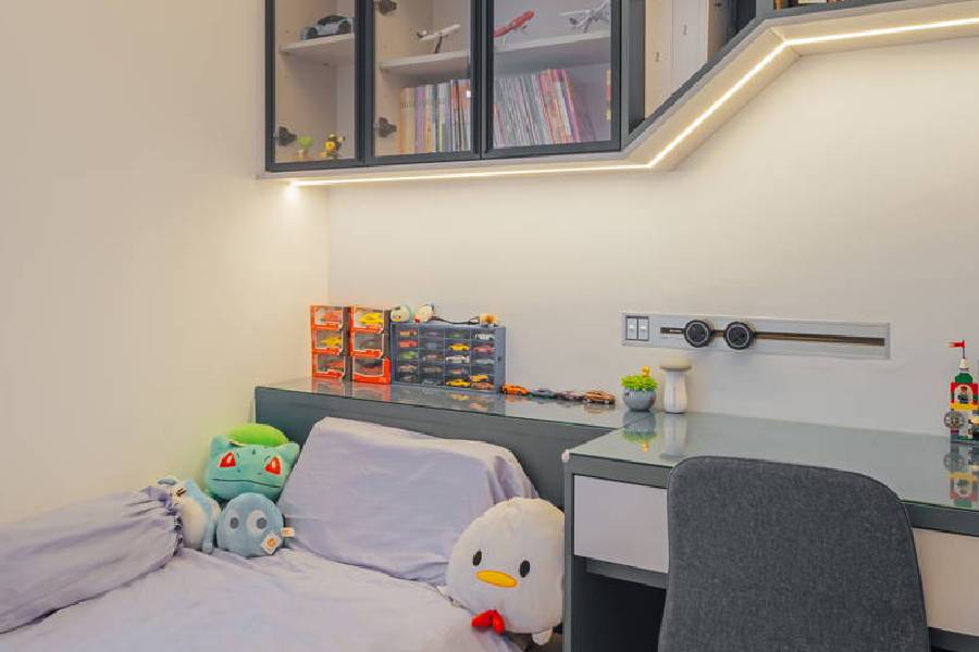 Children's bedroom renovation with built-in display shelving and study desk