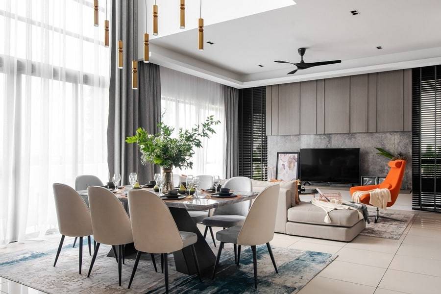 Open living and dining area with dark accent wall, TV console and dining table with pendant lighting