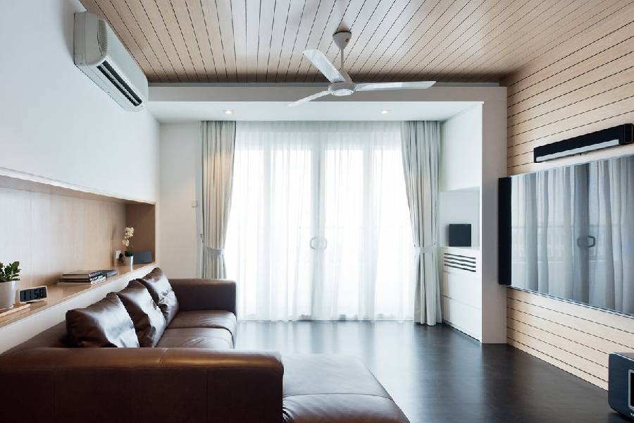 Living room with wood slat ceiling, feature wall and wall-mounted TV in a Thomson Renovation Contractor project
