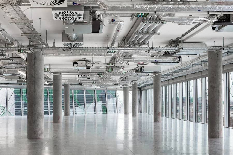 Vacant office floor plate with exposed ceiling services, ready for fit-out