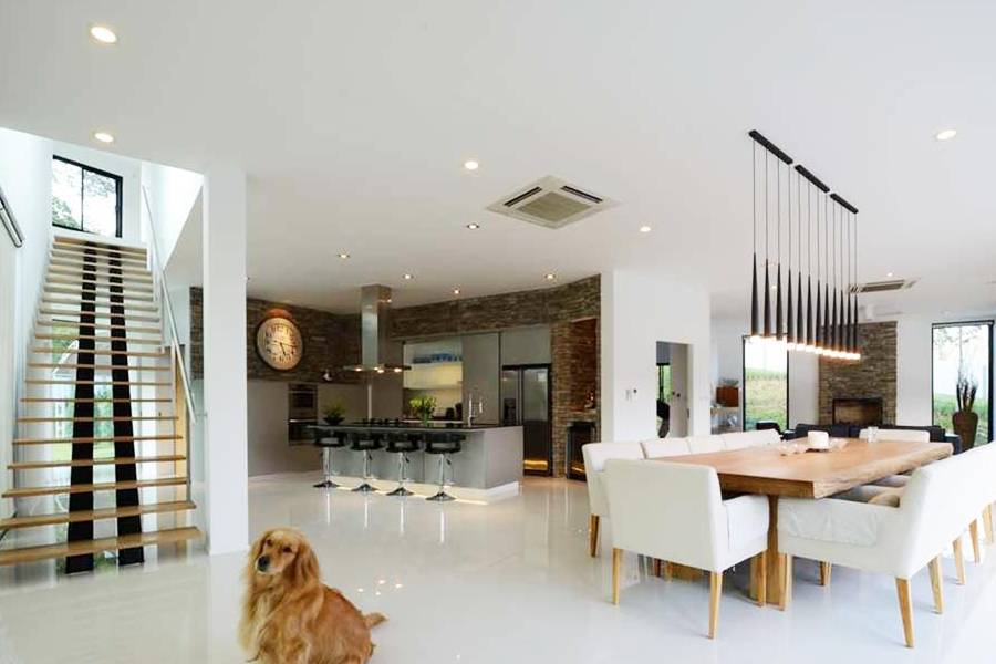 Landed home foyer with floating timber staircase and open-plan kitchen and dining area